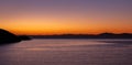 Aegean sea view from Kea island, Greece at sunset time, clear orange color sky background Royalty Free Stock Photo