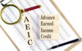 AEIC - Advance Earned Income Credit text on wooden block on chart background