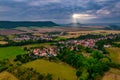 Aer ial view of a German village surrounded by meadows, farmland and forest.