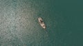 Aeral shot of a fishing boat sailing in the blue ocean in summer Royalty Free Stock Photo