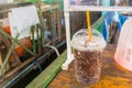 Aerated soft drink with ice in plastic glass