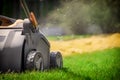 Aeration of the lawn in the garden. Yellow aerator on green grass Royalty Free Stock Photo