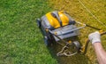 Aeration of the lawn in the garden. Yellow aerator on green grass Royalty Free Stock Photo