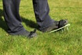 Aeration of the lawn with sandals. Garden concept