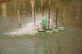 Aerator turbine wheel fill oxygen into water in lake Royalty Free Stock Photo