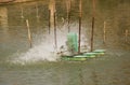 Aerator turbine wheel fill oxygen into water in lake Royalty Free Stock Photo