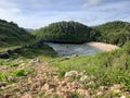 Aereal view of the lagoon sand beach Kasap with green hills.