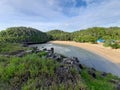 Aereal view of the lagoon sand beach Kasap with green hills.