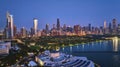 Aerial above aquarium with city lights at night reflection on Lake Michigan harbor water, Chicago IL