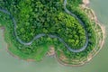 Aerial above view green mountain forest and river in the rain season and curved road on the hill connecting countryside Royalty Free Stock Photo