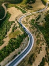 Aerial above view of a rural landscape with a curvy road running through it in Greece. Royalty Free Stock Photo