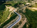 Aerial above view of a rural landscape with a curvy road running through it in Greece. Royalty Free Stock Photo