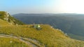 AERIAL: Active tourist couple preparing their campsite in the sunny mountains. Royalty Free Stock Photo