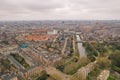 Aerial Amsterdam view from above in cloudy day, canals, streets and architectures