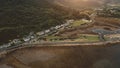 Aerial ancient castle ruins at sea. Nobody nature seascape at sun ocean bay. Buildings, cottages