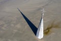 Aerial apocalyptic scene, church tower with cross buried under mud and toxic copper mining residuals Royalty Free Stock Photo