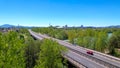 AERIAL: Asphalt freeway crosses the green landscape and leads towards Ljubljana.