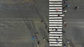 Aerial. Asphalt road with zebra pedestrian crosswalk and crowd of people. Top view Royalty Free Stock Photo