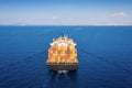 Aerial back view of a large container cargo vessel in motion