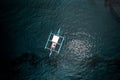 Aerial of a Bangka boat, watercraft captured on a turquoise ocean