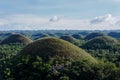 Aerial beautiful landscape of Chocolate Hills in Cebu Philippines under a blue sky