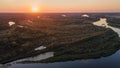 Aerial beautiful landscape drone shot of curved river and lakes and forest during sunrise