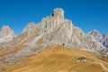 AERIAL: Beautiful rocky ridge towers over the golden meadows in Passo Giau.