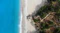 Aerial. Beautiful sea beach view with stone steps going up. Turquoise water with sandy coastline.