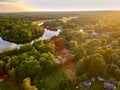 Aerial of a beautiful sunset over the trees and water in Blekinge, Sweden.