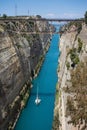 Aerial bird`s eye view photo taken by drone of famous Corinth Canal with turquoise water and lonely white yacht Royalty Free Stock Photo