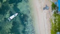 Aerial / bird view of the beach with a boat that is docked and nice blue ocean