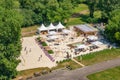 Aerial bird view over beach club Montego at the city park Rotehorn in Magdeburg, Germany, people playing beach volleyball at sunny