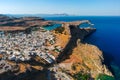 Aerial birds eye view drone photo of village Lindos, Rhodes island, Dodecanese, Greece. Sunset panorama with castle, Mediterranean