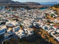 Aerial birds eye view drone photo of village Lindos, Rhodes island, Dodecanese, Greece. Sunset panorama with castle, Mediterranean