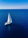 Aerial view from drone of white yacht in deep blue sea