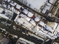 Aerial black and white winter top view of modern city with tall buildings, parked and moving cars along streets with road marking Royalty Free Stock Photo