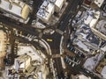 Aerial black and white winter top view of modern city with tall buildings, parked and moving cars along streets with road marking Royalty Free Stock Photo