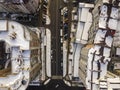 Aerial black and white winter top view of modern city with tall buildings, parked and moving cars along streets with road marking Royalty Free Stock Photo