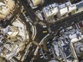 Aerial black and white winter top view of modern city with tall buildings, parked and moving cars along streets with road marking Royalty Free Stock Photo