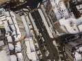 Aerial black and white winter top view of modern city with tall buildings, parked and moving cars along streets with road marking Royalty Free Stock Photo