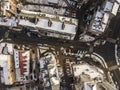 Aerial black and white winter top view of modern city with tall buildings, parked and moving cars along streets with road marking Royalty Free Stock Photo