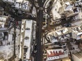 Aerial black and white winter top view of modern city with tall buildings, parked and moving cars along streets with road marking Royalty Free Stock Photo