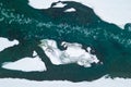 Aerial of a blue and green river with snow and crushed ice during an ice drift in winter in the Altai mountains in Russia Royalty Free Stock Photo