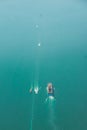 Aerial of a boat in a lagoon, sunlit seascape