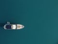 Aerial yacht on calm sea. Luxury cruise trip. View from above of white boat on deep blue water. Aerial top down view of Royalty Free Stock Photo