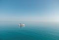 Aerial yacht on calm sea. Luxury cruise trip. View from above of white boat on deep blue water. Aerial view of rich