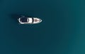 Aerial yacht on calm sea. Luxury cruise trip. View from above of white boat on deep blue water. Aerial view of rich