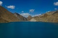 AERIAL: Breathtaking view of a large deep blue lake by the Manak Dam in Tibet.