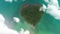 AERIAL. Camera moving trought clouds to heart shape island in Thailand.