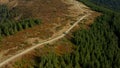 Aerial car on mountain road view going to camp among green rocky trees growing